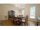 Elegant dining room featuring hardwood floors, wainscoting, and a chandelier, perfect for gatherings at 12037 Deer Run, Raleigh, NC 27614