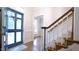Inviting entryway with a blue front door, hardwood floors, and a staircase at 12037 Deer Run, Raleigh, NC 27614