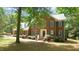 Charming brick home with classic blue shutters, a welcoming front porch, and lush, mature landscaping at 12037 Deer Run, Raleigh, NC 27614