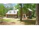 Charming two-story brick home with blue shutters, mature trees, and a well-manicured lawn at 12037 Deer Run, Raleigh, NC 27614