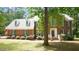 Charming two-story brick home with blue shutters and a well-manicured lawn and mature landscaping at 12037 Deer Run, Raleigh, NC 27614