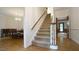 Hallway with carpeted stairs, wood trim, and hardwood floors at 12037 Deer Run, Raleigh, NC 27614