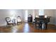 Elegant living room with hardwood floors, a piano, and two chairs at 12037 Deer Run, Raleigh, NC 27614