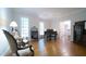 Open living room with hardwood floors, large windows, and antique furniture at 12037 Deer Run, Raleigh, NC 27614