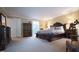 Primary bedroom featuring ample space, furniture, and access to the en suite bathroom at 12037 Deer Run, Raleigh, NC 27614