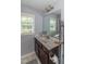 Bathroom featuring a sink with marble countertops, a large mirror, and a window at 121 Longleaf Pine St, Clayton, NC 27527
