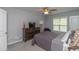 Comfortable bedroom with neutral colors, a ceiling fan, and plenty of natural light at 121 Longleaf Pine St, Clayton, NC 27527