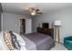 Cozy bedroom featuring a ceiling fan, comfortable bed, and a view of the backyard at 121 Longleaf Pine St, Clayton, NC 27527