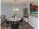 Dining area with a marble table and modern lighting adjacent to the kitchen at 121 Longleaf Pine St, Clayton, NC 27527