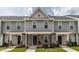 Charming townhouse with a covered front porch and well-maintained landscaping, showcasing curb appeal at 121 Longleaf Pine St, Clayton, NC 27527