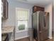 Bright kitchen with stainless steel fridge, granite countertops, and natural light at 121 Longleaf Pine St, Clayton, NC 27527