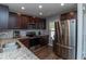 Well-equipped kitchen with granite countertops, stainless steel appliances, and wood cabinets at 121 Longleaf Pine St, Clayton, NC 27527