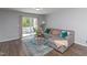 Stylish living room with a comfortable gray couch, sliding glass doors to the patio, and a vibrant rug at 121 Longleaf Pine St, Clayton, NC 27527