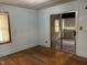Bedroom with hardwood floors, light blue walls, and a sliding glass door at 129 S Bullock St, Henderson, NC 27536