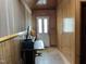 Bonus room with wood paneling, an exterior door, and a desk at 129 S Bullock St, Henderson, NC 27536