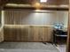 Finished bonus room with wood paneling, carpet, and a security monitor at 129 S Bullock St, Henderson, NC 27536