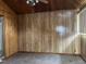 Bonus room with wood paneling, carpet, and a view of the backyard at 129 S Bullock St, Henderson, NC 27536
