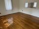 Hardwood floors and natural light in a spacious living room at 129 S Bullock St, Henderson, NC 27536