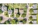 Aerial view of the property showcasing the neighborhood, surrounding trees, and driveway at 1304 Trailing Rose Ct, Wake Forest, NC 27587