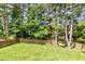 View of the expansive, well-manicured backyard with mature trees at 1304 Trailing Rose Ct, Wake Forest, NC 27587