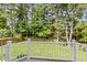 Lush backyard view from the deck, featuring a well-maintained lawn and privacy fence at 1304 Trailing Rose Ct, Wake Forest, NC 27587