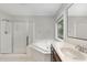 Bathroom with double sink vanity, a large tub, and a separate shower at 1304 Trailing Rose Ct, Wake Forest, NC 27587