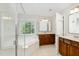 Bathroom with double sink vanity, a large tub, and a separate shower at 1304 Trailing Rose Ct, Wake Forest, NC 27587
