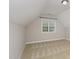 Upstairs bedroom featuring carpeted floors and natural light at 1304 Trailing Rose Ct, Wake Forest, NC 27587