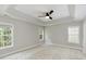 Bedroom with neutral carpet, a ceiling fan, and three windows at 1304 Trailing Rose Ct, Wake Forest, NC 27587
