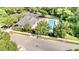 Community pool area with lounge chairs, tables, and a clubhouse surrounded by trees at 1304 Trailing Rose Ct, Wake Forest, NC 27587