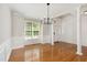 Elegant dining room with hardwood floors, modern chandelier, and ample natural light at 1304 Trailing Rose Ct, Wake Forest, NC 27587