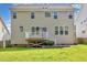 Rear exterior view of the home, showcasing the siding, windows, deck, and backyard at 1304 Trailing Rose Ct, Wake Forest, NC 27587