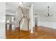 Inviting foyer with hardwood floors, staircase, and views into adjoining rooms at 1304 Trailing Rose Ct, Wake Forest, NC 27587