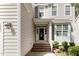 Close up of front entrance with brick steps and sidelights, showcasing the home's curb appeal at 1304 Trailing Rose Ct, Wake Forest, NC 27587