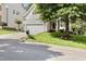 Beautiful home with manicured front yard, tree, and an inviting entrance at 1304 Trailing Rose Ct, Wake Forest, NC 27587