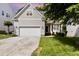 Well maintained home with a two-car garage, manicured lawn, and classic curb appeal at 1304 Trailing Rose Ct, Wake Forest, NC 27587