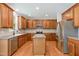 Spacious kitchen with stainless appliances, wooden cabinetry, and a kitchen island at 1304 Trailing Rose Ct, Wake Forest, NC 27587