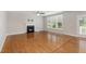 Spacious living room with hardwood floors, fireplace, and plenty of natural light at 1304 Trailing Rose Ct, Wake Forest, NC 27587