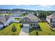 Aerial view of a home with a large yard in a residential neighborhood with mature trees and a playground nearby at 1305 Ivey Grove Ct, Fuquay Varina, NC 27526