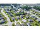 Aerial view of a neighborhood featuring manicured lawns, mature trees, and community amenities at 1305 Ivey Grove Ct, Fuquay Varina, NC 27526