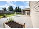 Well-maintained backyard with a patio, screened porch, garden beds, and a fire pit at 1305 Ivey Grove Ct, Fuquay Varina, NC 27526