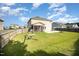 Spacious backyard with lush grass, a swing set, a fire pit, and a screened porch at 1305 Ivey Grove Ct, Fuquay Varina, NC 27526