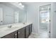 Bathroom with a double sink vanity, large mirror and tiled floors at 1305 Ivey Grove Ct, Fuquay Varina, NC 27526