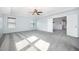 Spacious bedroom featuring a ceiling fan, tray ceiling and plush gray carpeting at 1305 Ivey Grove Ct, Fuquay Varina, NC 27526