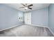 Bedroom with neutral walls, gray carpet, a ceiling fan, and a window for natural light at 1305 Ivey Grove Ct, Fuquay Varina, NC 27526