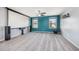 Bonus room with plush carpeting, a mounted projector screen, and windows for natural light at 1305 Ivey Grove Ct, Fuquay Varina, NC 27526