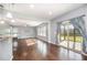 Open living room with hardwood floors, recessed lighting, large windows, and access to an outdoor screened porch at 1305 Ivey Grove Ct, Fuquay Varina, NC 27526