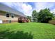 Grassy backyard features a wood deck, lawn, and wood fence at 1309 Sweet Charm Ln, Knightdale, NC 27545