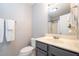 This partial view of a bathroom shows a single sink vanity with gray cabinets and marble countertops at 1309 Sweet Charm Ln, Knightdale, NC 27545