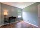 This bright bedroom features a window and wood-look floors that complement the gentle green wall paint at 1309 Sweet Charm Ln, Knightdale, NC 27545